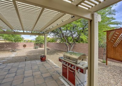 The 600-square-foot patio offers a full patio set and large pergola
